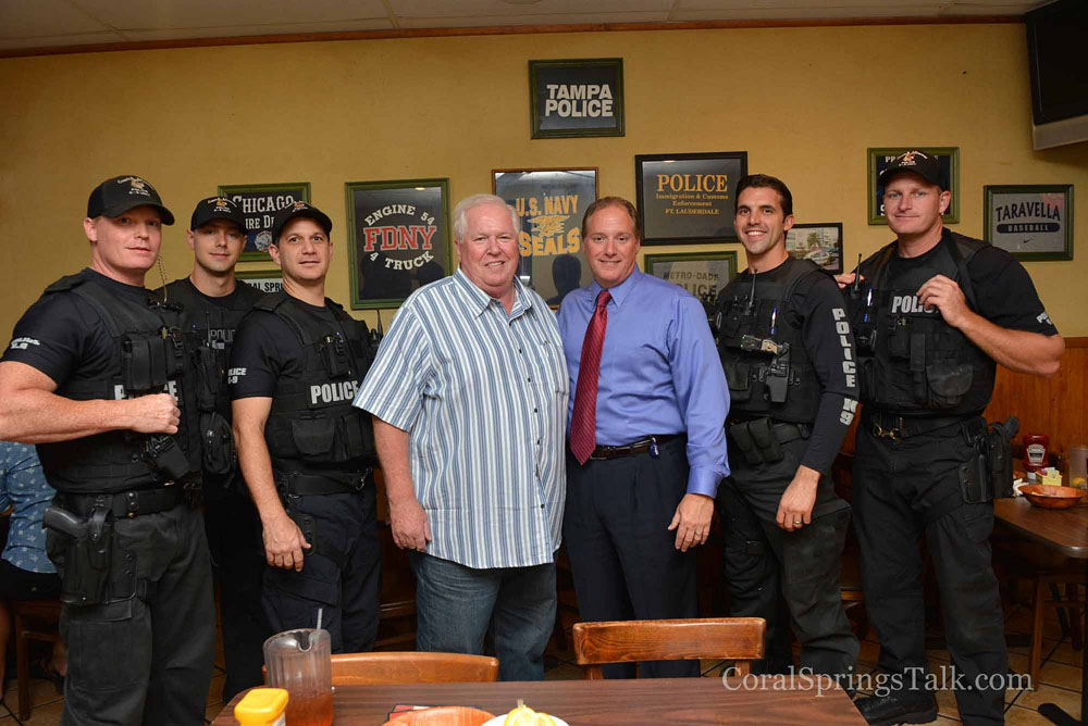 Wings Plus owner Brian Walsh along with Coral Springs Police Chief  Tony Pustizzi and officers.