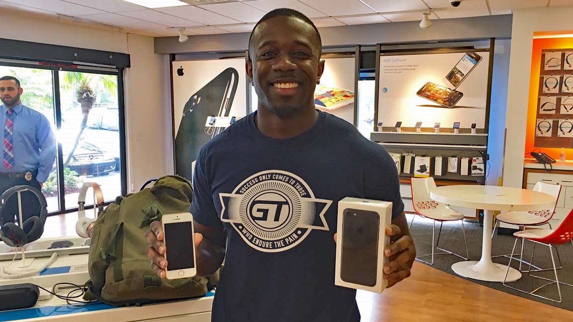 Henry holding his water damaged iPhone 4 in one hand (left) and his new, much larger, iPhone 7 in the other hand.  Photos Courtesy AT&T.