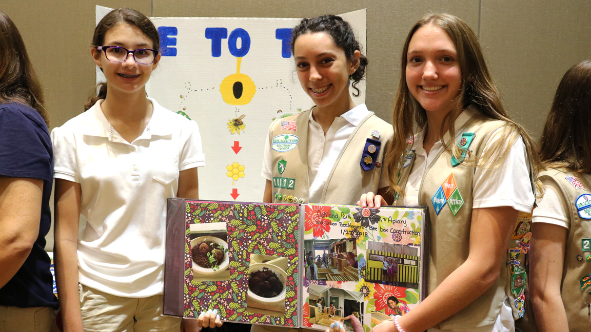 Fiona B., Marissa C. and Lynnae V. presenting their Silver Award Project “Bee Scouts Saving Bees” at Girl Scouts of Southeast Florida’s 2019 Silver Award Showcase. {Courtesy Girl Scouts Southeast Florida}.